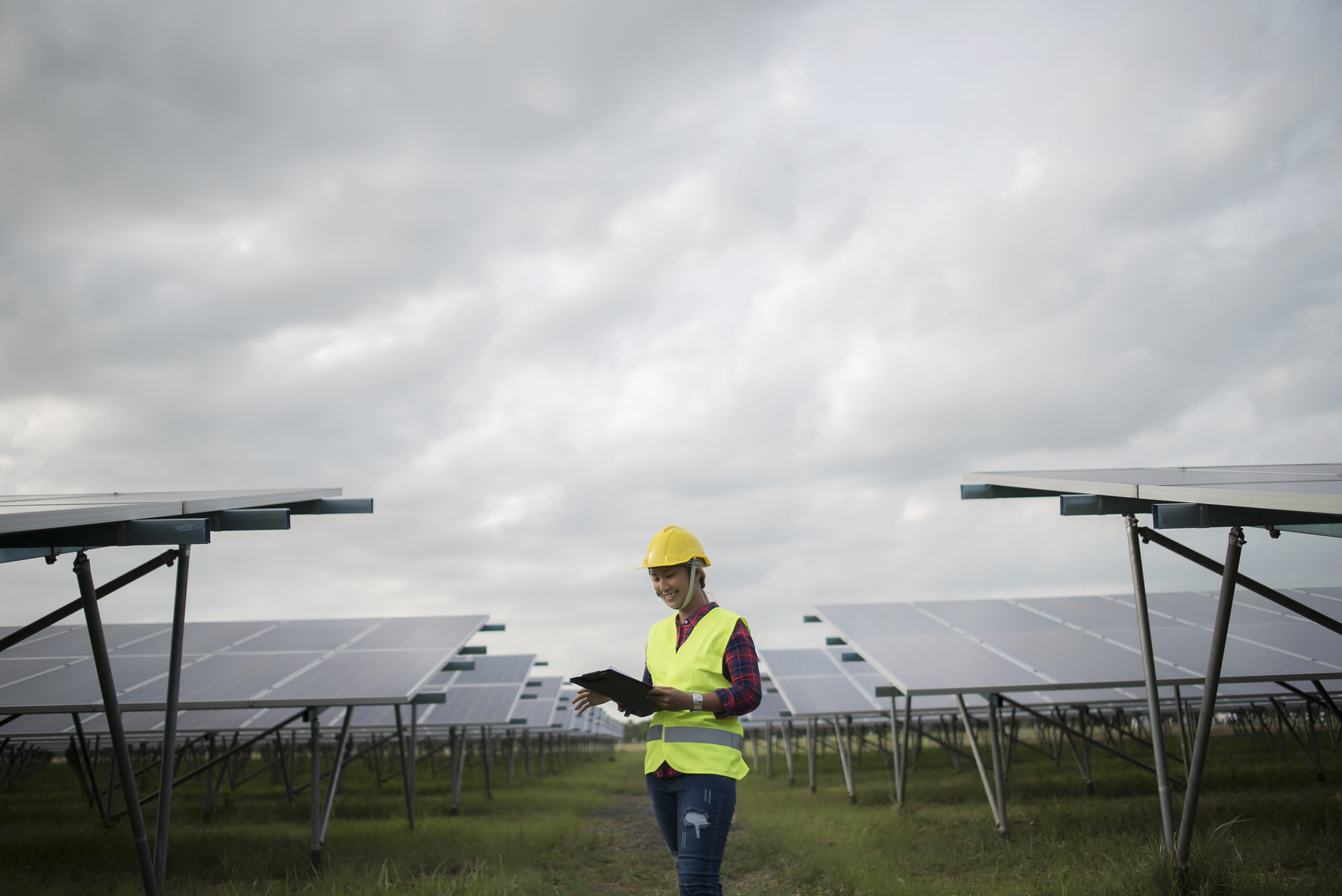 Engineer electric woman checking and maintenance of solar cells.